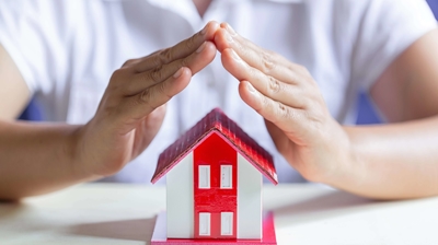 hands above a toy house