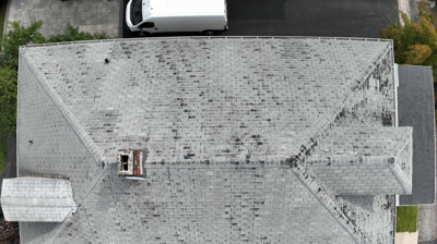 Happy customer after a successful roofing project by Mighty Dog Roofing of Rhode Island.