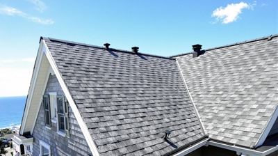 Ultimate Rhode Island roofing guide cover showing coastal home with professional roofing installation