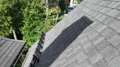 Snow retention rails installed below solar panels on a Providence Rhode Island roof