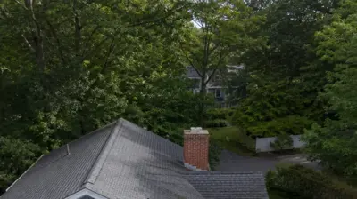 Drone view of roof moss on a shaded Smithfield, RI home roof