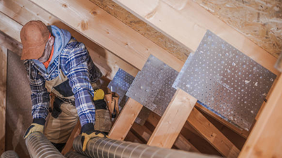 Expert contractor installing ventilation system