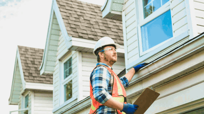 Roofer conducting roof replacement estimate