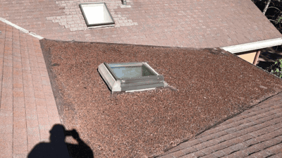 Roofer conducting a detailed roof inspection