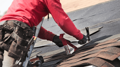 roofer completing emergency roof repair