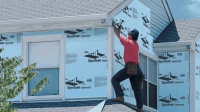 Siding contractor installing insulated siding