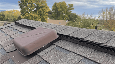Ridge vent and box vent roof ventilation systems installed on home