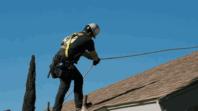 Roofer performing storm preparation maintenance