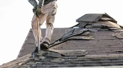 Roofing contractor preparing roof for replacement