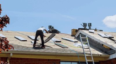Roofing contractor performing roof replacement