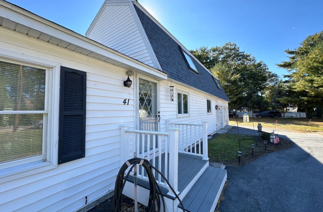 A Mighty Dog Roofing crew cutting and fitting new gutters in Burlington, MA to provide a leak-free system with lasting durability and curb appeal.