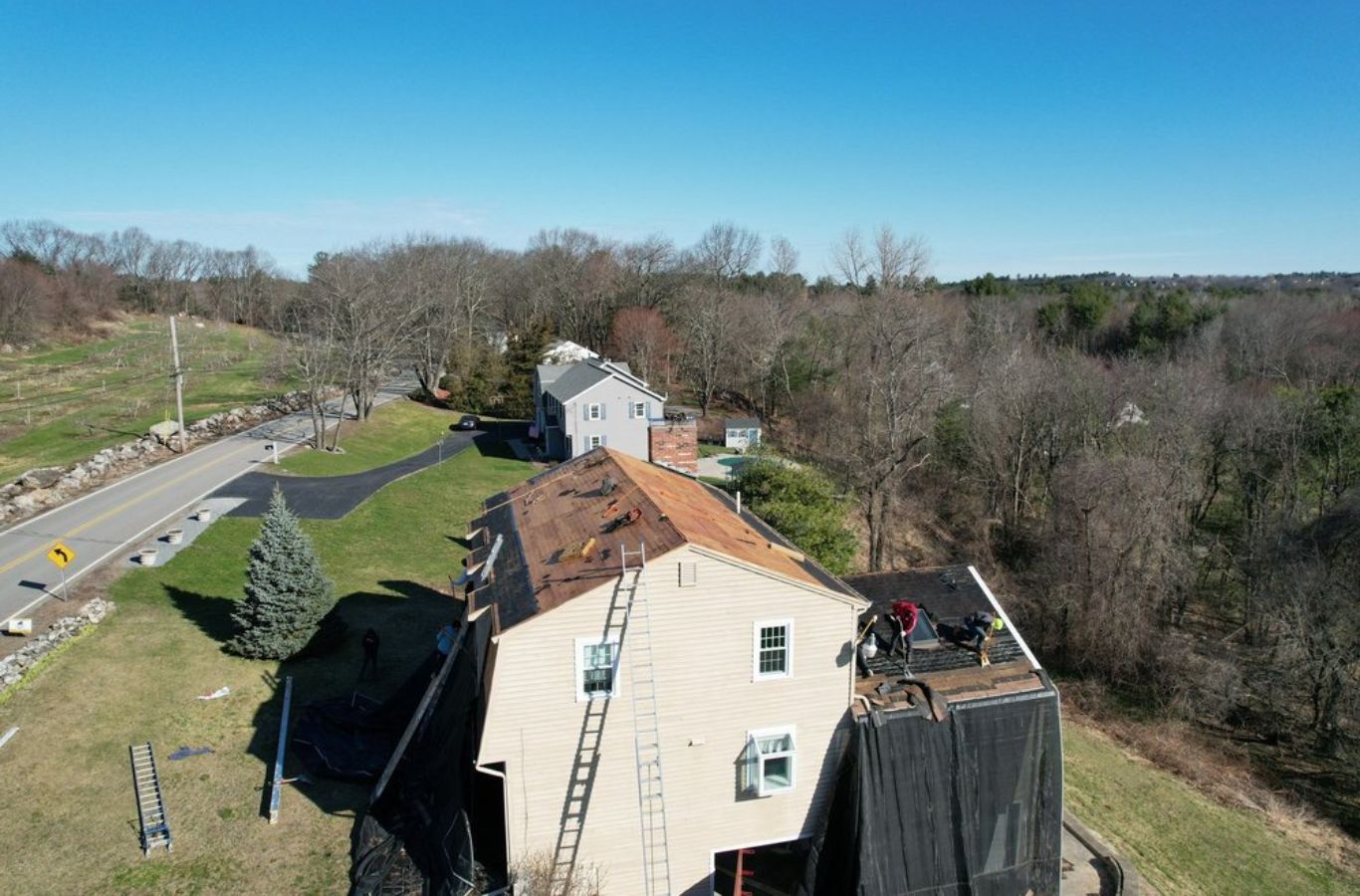 A Mighty Dog Roofing of Greater Middlesex County team member repairing a roof in Arlington, MA, showcasing attention to detail.