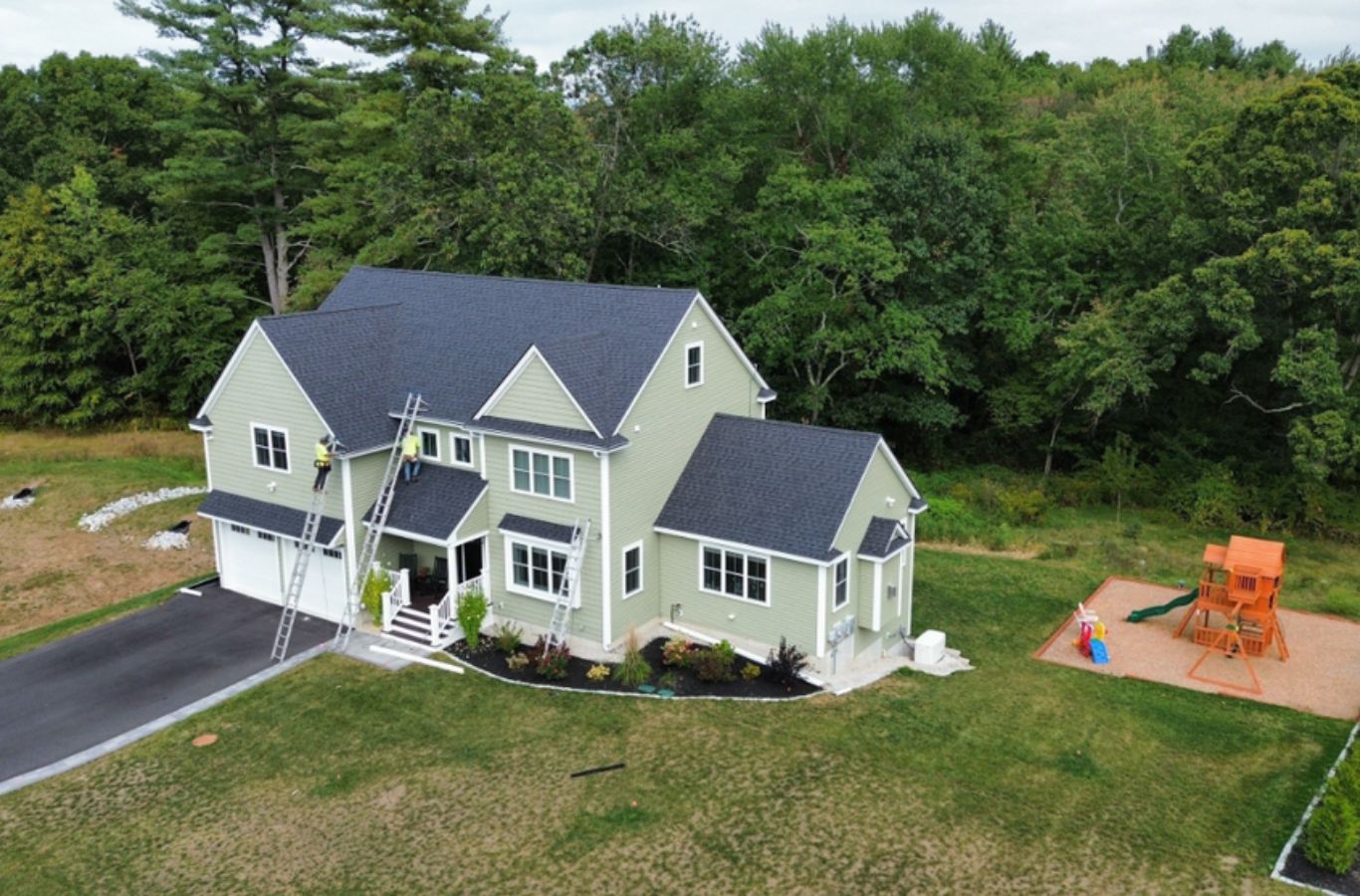 A Mighty Dog Roofing of Greater Middlesex County technician installing siding in Burlington, MA with precision tools, durable panels, and skilled craftsmanship.