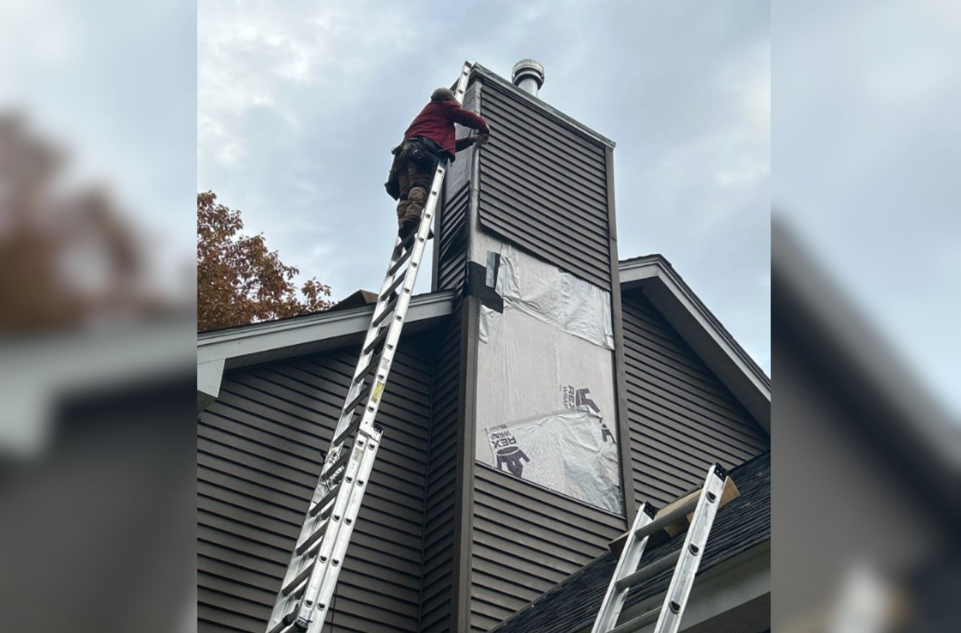 A Mighty Dog Roofing professional completing trim work on a home in Stow, MA, highlighting detail and high-quality siding install. Siding Company near me.