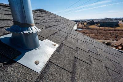 Metal flashing installed around a vent on a residential roof