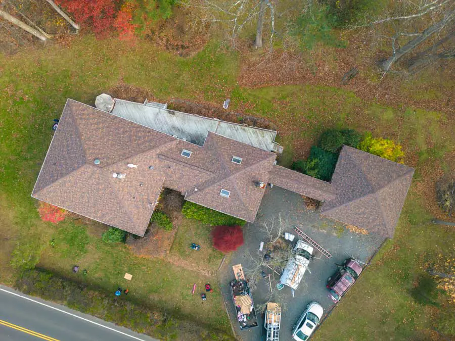 Aerial view of a completed asphalt shingle roof on a residential home in Alpine, NJ, showing clean lines and proper installation completed by Mighty Dog Roofing of Northeast New Jersey