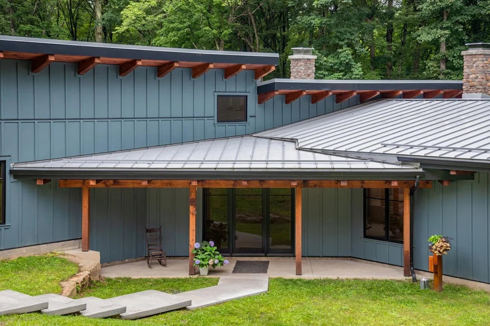 blue siding on a home with cedar accents