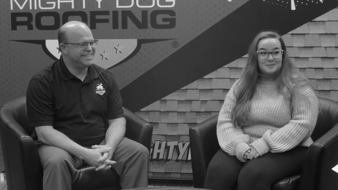 man and woman talking in an interview setting
