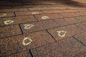 Hail damage on shingles on a Commerce City, CO home after the May 2024 baseball-sized hailstorm