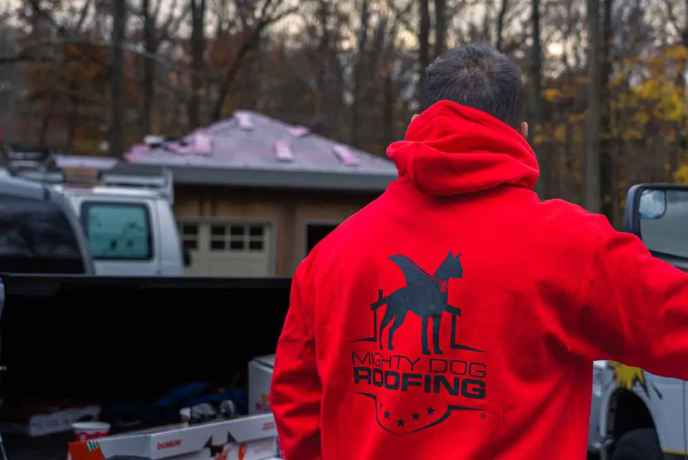 Mighty Dog Roofing team on-site at a residential roof inspection in Alpine, NJ, preparing for a roofing project.