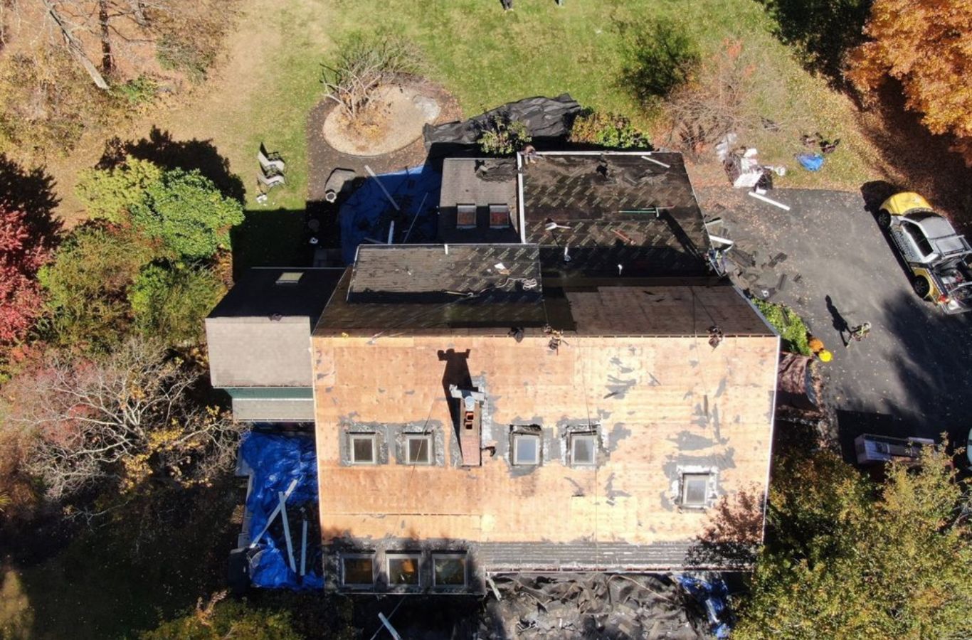 Mighty Dog Roofing team mid-installation on a Lincoln, MA rooftop, representing the advantages of a reliable, expert local roofing service.