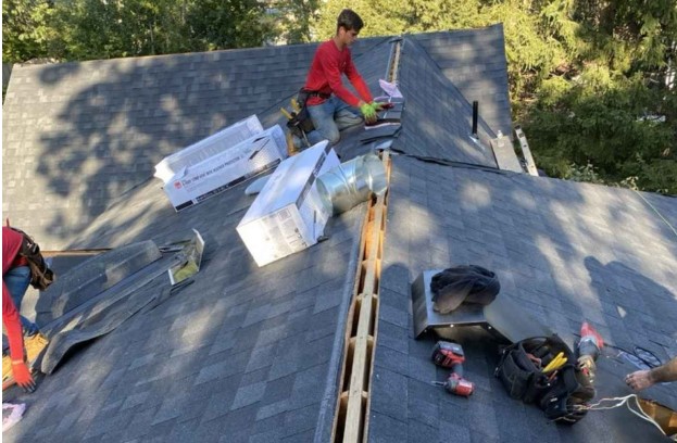 Carlisle, MA home undergoing roof inspection by a local Mighty Dog Roofing technician.