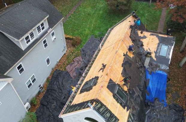 Roofing installation by Mighty Dog Roofing on a sunny day in Stow, MA. Roofing Company near me.