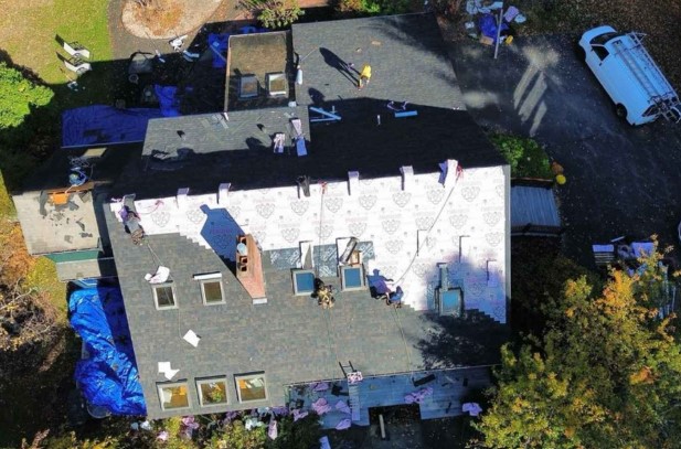 Roofing contractor completing installation on a Tyngsborough, MA residence. Roofing Company near me.