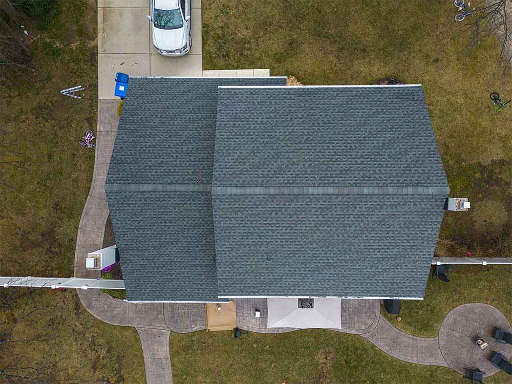 Aerial drone view of a completed asphalt shingle roof replacement on a residential home in South Jersey