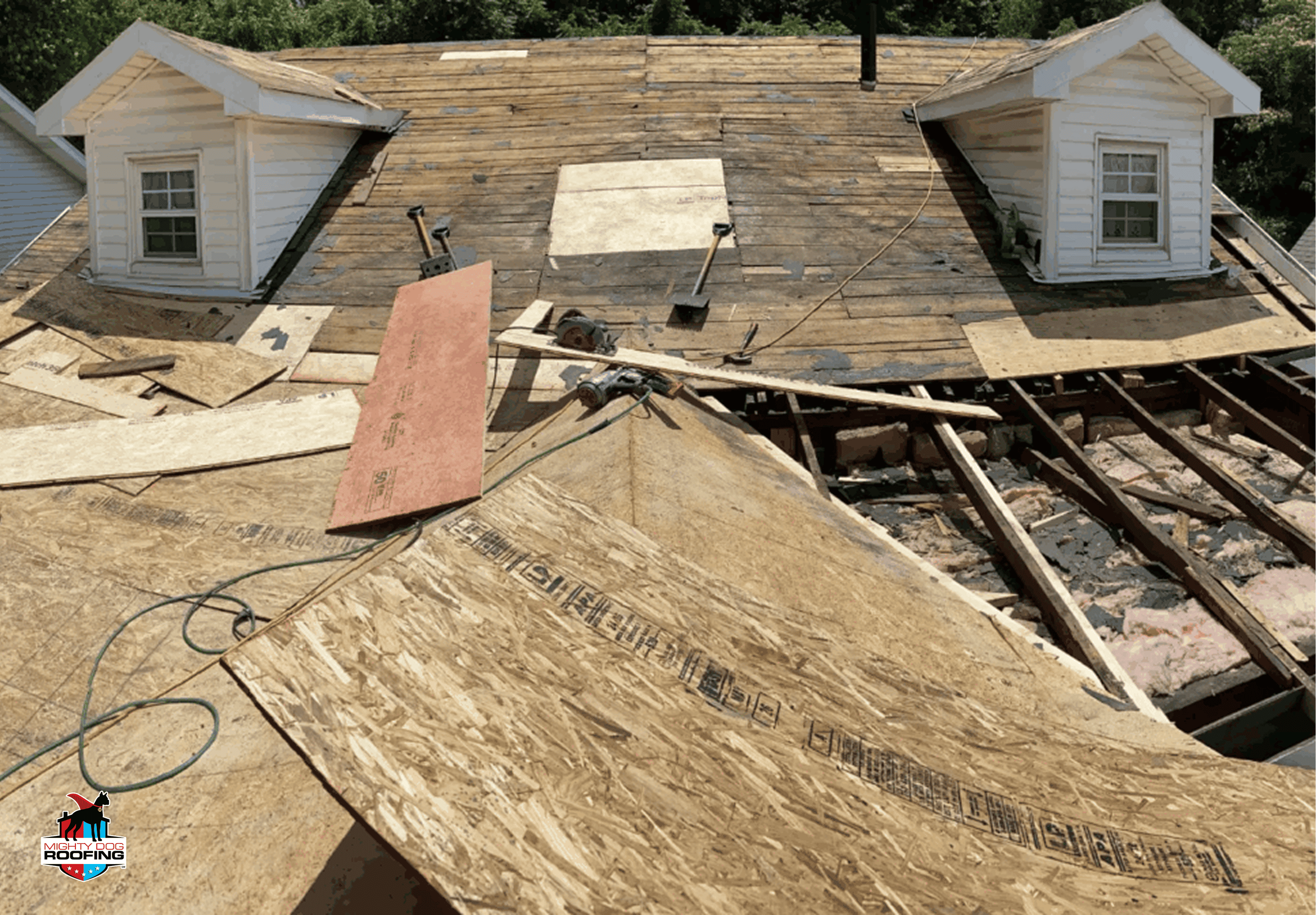 Contractor removing old shingles for roof replacement